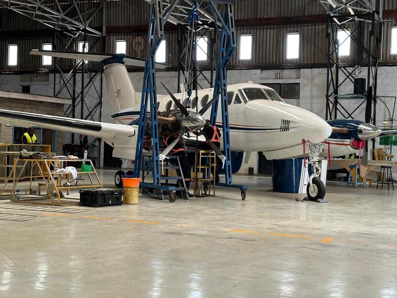 Engineers working on a King Air engine in the Westwind Aviation maintenance hangar